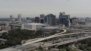 5.7K aerial stock footage of passing by Amway Center and city skyline, Downtown Orlando, Florida Aerial Stock Footage | DX0003_234_017