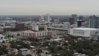 5.7K aerial stock footage of apartment complex, Amway Center and city skyline, Downtown Orlando, Florida Aerial Stock Footage | DX0003_234_020