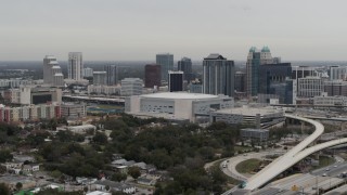 DX0003_234_029 - 5.7K aerial stock footage of Amway Center arena and city skyline, Downtown Orlando, Florida