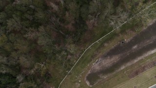 5.7K aerial stock footage descend toward clearing on edge of forest, Orlando, Florida Aerial Stock Footage | DX0003_234_049