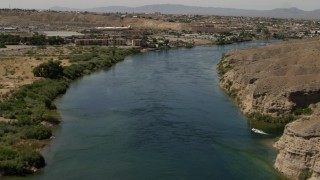 4K aerial stock footage follow the Colorado River past a small riverfront hotel in Bullhead City, Arizona Aerial Stock Footage | FG0001_000009