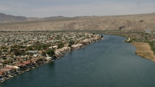 4K aerial stock footage of waterfront homes with docks beside the Colorado River in Bullhead City, Arizona Aerial Stock Footage | FG0001_000014