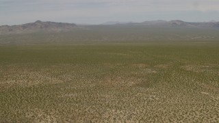 4K aerial stock footage tilt to reveal distant mountains and fly over open Mojave Desert in Laughlin, Nevada Aerial Stock Footage | FG0001_000032