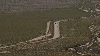 4K aerial stock footage of bus and cars traveling on a Mojave Desert highway in Laughlin, Nevada Aerial Stock Footage | FG0001_000033