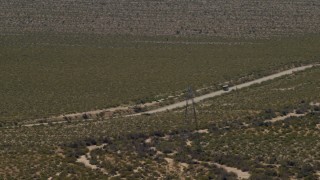 FG0001_000034 - 4K aerial stock footage of a bus traveling on a lonely Mojave Desert highway in Laughlin, Nevada