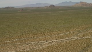 4K aerial stock footage fly over Mojave Desert landscape to approach hills in San Bernardino County, California Aerial Stock Footage | FG0001_000040