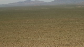 4K aerial stock footage fly over arid desert to approach mountains in Mojave Desert, San Bernardino County, California Aerial Stock Footage | FG0001_000043