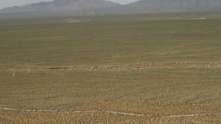 4K aerial stock footage fly over the Mojave Desert to approach mountains in San Bernardino County, California Aerial Stock Footage | FG0001_000044