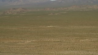 4K aerial stock footage fly over the Mojave Desert to approach hills and mountains in San Bernardino County, California Aerial Stock Footage | FG0001_000045