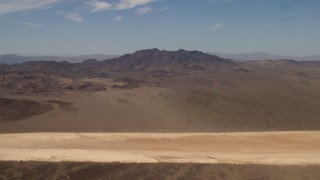 4K aerial stock footage of a dry lake and Mojave Desert mountains in San Bernardino County, California Aerial Stock Footage | FG0001_000062