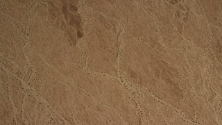 4K aerial stock footage of looking down at a barren Mojave Desert plain in San Bernardino County, California Aerial Stock Footage | FG0001_000072