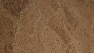 4K aerial stock footage of looking down at an arid Mojave Desert plain in San Bernardino County, California Aerial Stock Footage | FG0001_000073