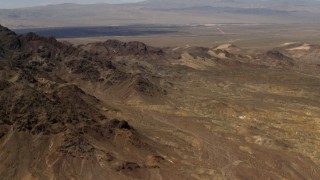 4K aerial stock footage of the Pisgah Crater behind rugged Mojave Desert mountains in San Bernardino County, California Aerial Stock Footage | FG0001_000079