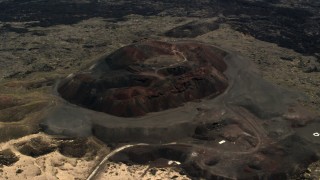 4K aerial stock footage of a reverse view of the Pisgah Crater cinder cone in the Mojave Desert, San Bernardino County, California Aerial Stock Footage | FG0001_000093