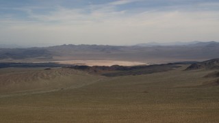 4K aerial stock footage of a dry lake and distant mountains in the Mojave Desert, San Bernardino County, California Aerial Stock Footage | FG0001_000095