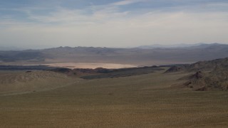 4K aerial stock footage of a distant dry lake and mountains in the Mojave Desert, San Bernardino County, California Aerial Stock Footage | FG0001_000096