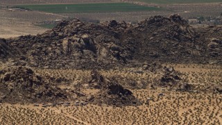 FG0001_000120 - 4K aerial stock footage of the Cougar Buttes and RVs in the Mojave Desert, San Bernardino County, California