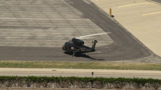 4K aerial stock footage of a civilian helicopter at Whiteman Airport, Pacoima, California Aerial Stock Footage | FG0001_000152