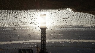 4K aerial stock footage zoom closer to a glowing power tower boiler at the Ivanpah Solar Electric Generating System in California Aerial Stock Footage | FG0001_000207