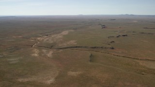 FG0001_000230 - 4K aerial stock footage of a dry riverbed and a desert plain in the Arizona Desert