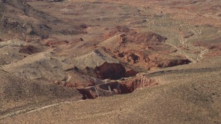 4K aerial stock footage of sheer red slopes of rocky hills around a shallow box canyon in the Nevada Desert Aerial Stock Footage | FG0001_000253