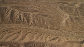 4K aerial stock footage tilt from a bird's eye view of hills in the Nevada Desert to reveal the wider landscape and Lake Mead Aerial Stock Footage | FG0001_000268