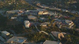 HDA06_05 - HD stock footage aerial video approach and fly over Universal Studios Hollywood at sunset, Universal City, California