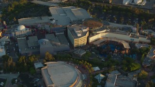 HDA06_06 - HD stock footage aerial video fly over Universal Studios Hollywood and tilt to the Waterworld attraction at sunset, Universal City, California