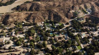 HD stock footage aerial video fly over homes and brown hills in Newhall, California Aerial Stock Footage | HDA07_17