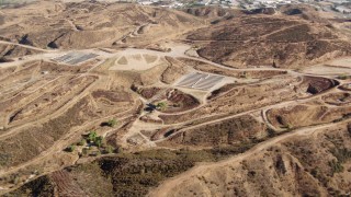 HDA07_18 - HD stock footage aerial video fly over hills to new home construction, Santa Clarita Valley, California