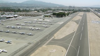 HDA07_44 - HD stock footage aerial video of flying over Whiteman Airport, pan to aircraft, Pacoima, California