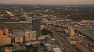 HD stock footage aerial video of flying away from freeway interchange to reveal skyscrapers at sunset in Downtown Fort Worth, Texas Aerial Stock Footage | HDA12_013