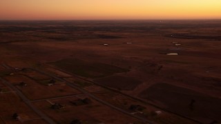 HDA12_026 - HD stock footage aerial video of flying by rural homes and farmland at sunrise in Decatur, Texas