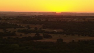 HD stock footage aerial video of the rising sun beyond farms and rural homes in Decatur, Texas Aerial Stock Footage | HDA12_038