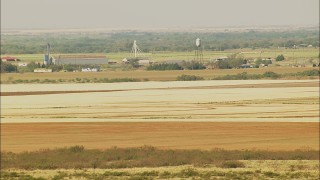 HD stock footage aerial video of a reverse view of barns and a water tower on a farm in Walters, Oklahoma Aerial Stock Footage | HDA12_090