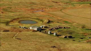 HDA12_104 - HD stock footage aerial video of hay bales and pond on a farm in Temple, Oklahoma