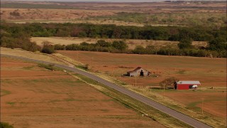 HD stock footage aerial video of a barn and fields beside a country road, reveal grazing cows in Oklahoma Aerial Stock Footage | HDA12_115