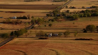 HD stock footage aerial video of farms and a country road at sunset in Meridian, Oklahoma Aerial Stock Footage | HDA12_128