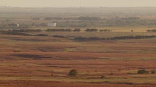 HD stock footage aerial video of large tanks and farmland at sunset in Oklahoma Aerial Stock Footage | HDA12_130