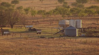 HD aerial stock of silos and farm equipment at sunset in Oklahoma Aerial Stock Footage | HDA12_137