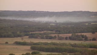 HD stock footage aerial video of smoke rising from trees at sunset in Texas Aerial Stock Footage | HDA12_162