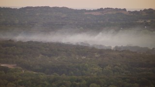 HD stock footage aerial video of thick smoke rising from trees at sunset in Texas Aerial Stock Footage | HDA12_163