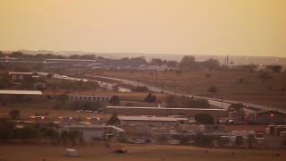 HDA12_175 - HD stock footage aerial video of industrial buildings near highway interchange, Decatur, Texas, sunset