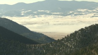 HDA13_305 - HD stock footage aerial video of Park Country valley with fog and snow on Rocky Mountains, Colorado