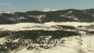 HD stock footage aerial video of flying over a snowy valley to approach Rocky Mountains, Park County, Colorado Aerial Stock Footage | HDA13_320