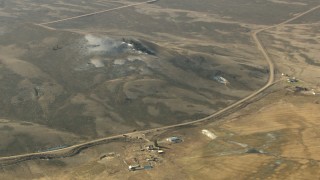 HD stock footage aerial video of zooming from a hill to reveal a farm in Colorado Aerial Stock Footage | HDA13_329