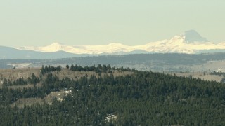 HD aerial stock footage video of snowy Rocky Mountains seen beyond a ridge, Colorado Aerial Stock Footage | HDA13_333