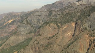 HD stock footage aerial video tilt up a snowy slope, reveal rockier slopes in the Rocky Mountains, Colorado Aerial Stock Footage | HDA13_351