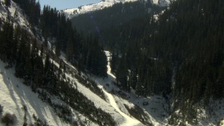 HDA13_355_03 - HD stock footage aerial video fly through a canyon between snowy Rocky Mountains, Colorado