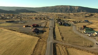 HDA13_395_02 - HD stock footage aerial video of flying over fields and grazing animals on the way to Ridgway, Colorado at sunset